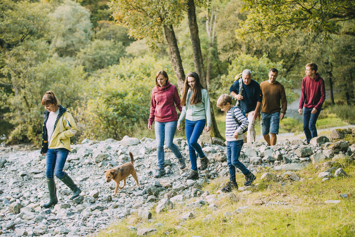 people walking dog in nature