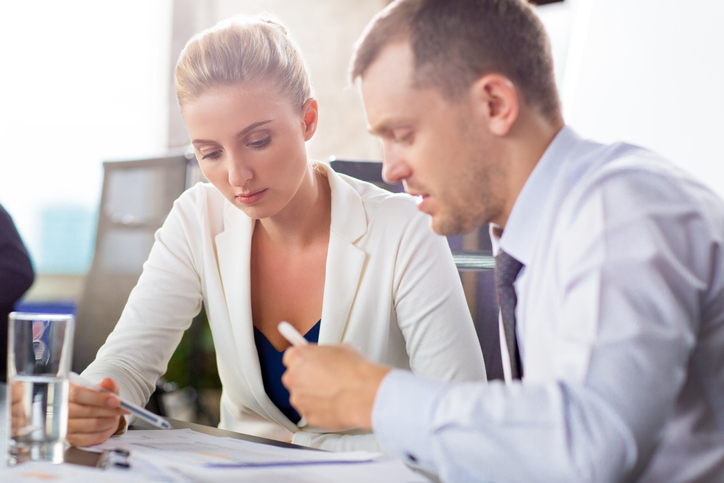 man and woman speaking at work