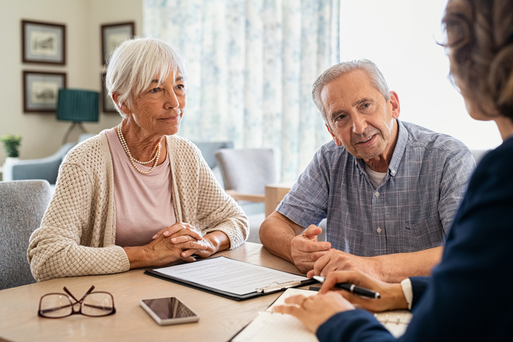 Two elderly people (man and woman) talking about Right of Survivorship in a family lawyer's office in Victoria BC.